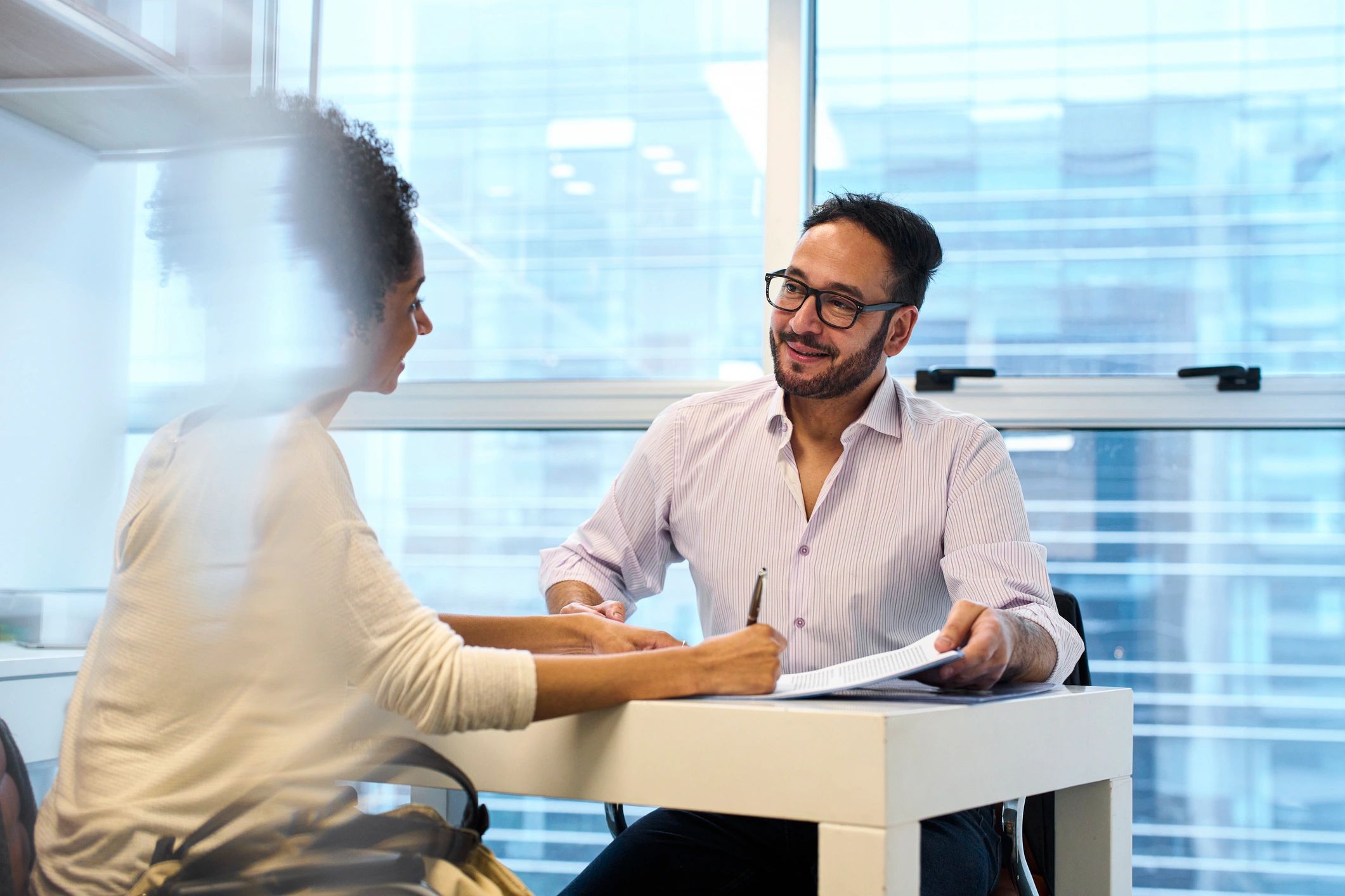 Black female professional advising a client in an office setting