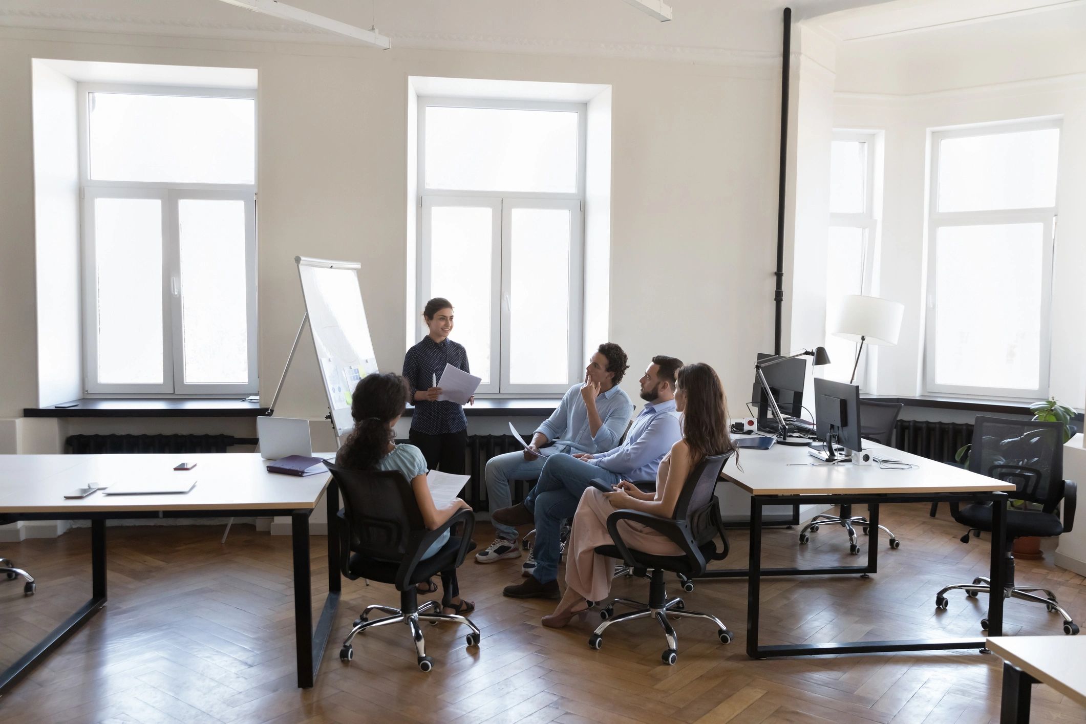 Black female professional leading a workshop in an office setting
