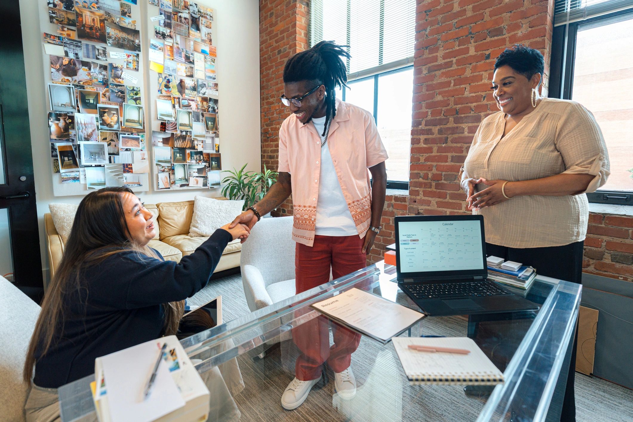 Black female professional advising clients in a modern office consultation setting