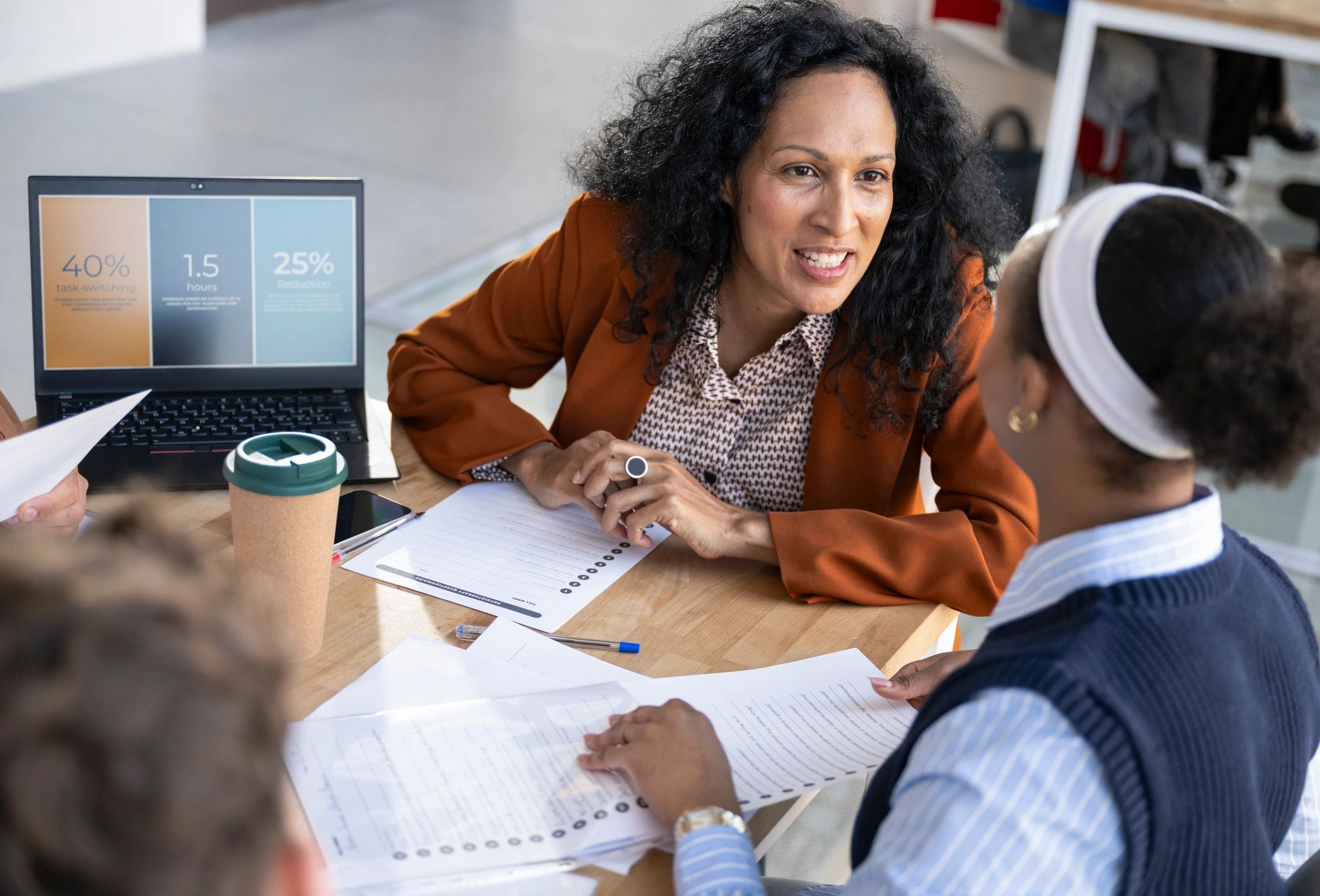 Black female consultant advising clients in a professional office setting
